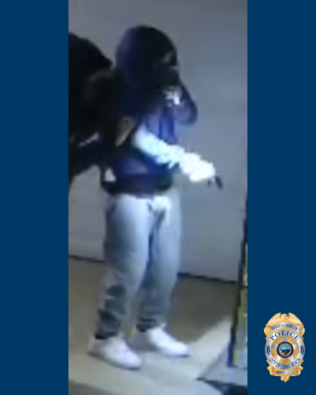 Blurry photo of a man in a blue hoodie and gray pants and white shoes.