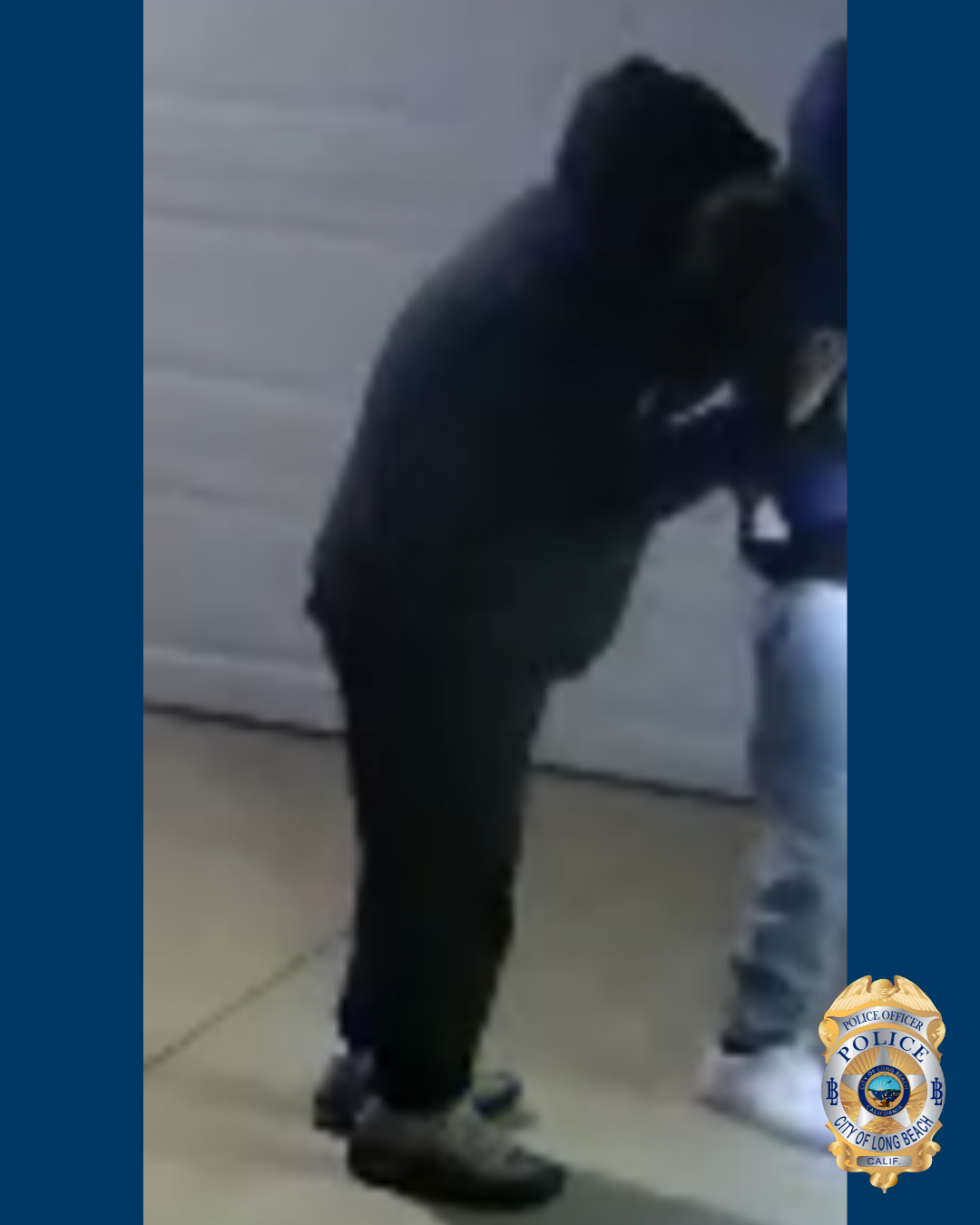 Blurry photo of a man in dark clothing and dark shoes.
