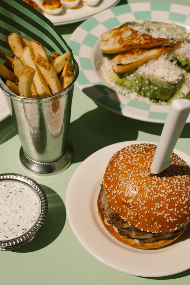 The Dose Delux half-pound Wagyu burger with fries and house-made ranch dressing at Coffee Dose Brunch Club, which opens Friday, June 12, in The Ranch at Rancho Santa Fe shopping center in Encinitas. (Jordan Shiley)