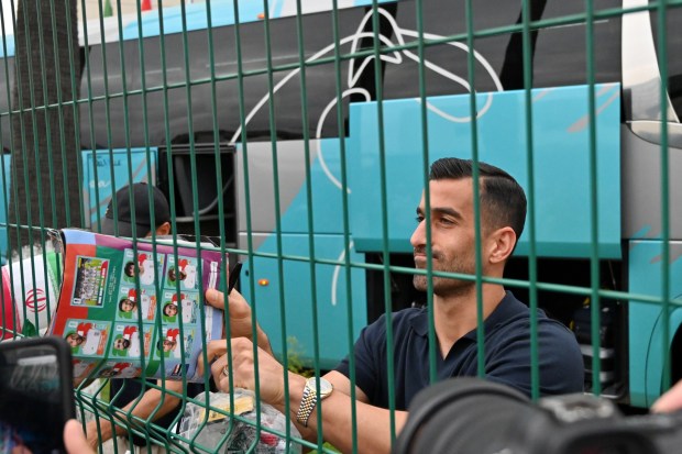 Iran's defender #03 Ehsan Hajsafi and teammates sign autographs for fans as they leave the Marriott Hotel at their Tijuana base camp ahead of the Iran National Team's departure following its elimination from the 2026 World Cup football tournament in Tijuana, Mexico on Tuesday, June 30, 2026. (Carlos Moreno / The San Diego Union-Tribune)