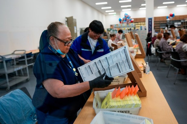 Before sending the ballots for tabulation for the 2026 primary election, poll workers at the San Diego County Registrar of Voters extract and prepare them on Election Day, Tuesday, June 2, 2026. (Nelvin C. Cepeda / The San Diego Union-Tribune)