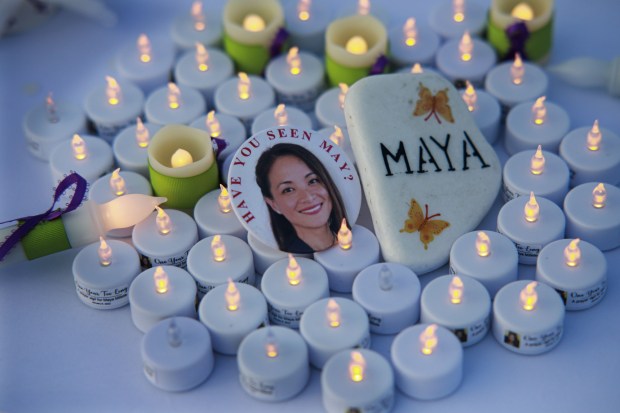 A button and candles on display at a prayer vigil for May Millete in honor of the first anniversary of her disappearance at Chula Vista Community Park on Jan. 8, 2022. (Sandy Huffaker / For The San Diego Union-Tribune)