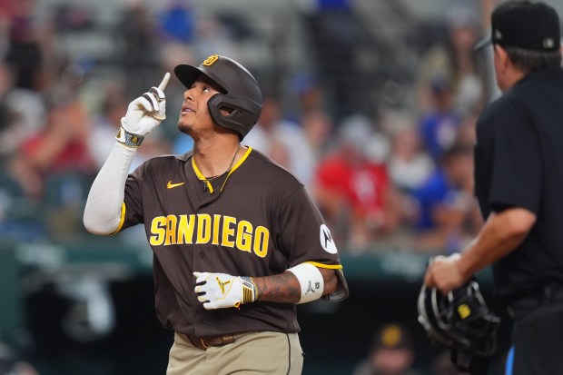 The Padres' Manny Machado crosses the plate after his three-run homer in the 10th inning of Saturday's victory over the Rangers. (AP Photo/LM Otero)