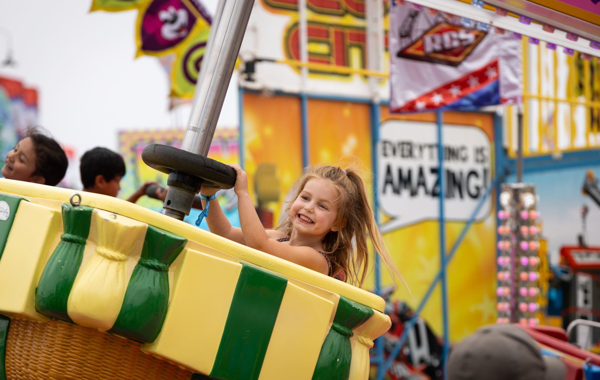A child rides the Up Up and Away Ride at...
