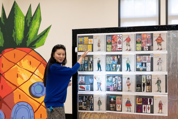 Costume designer Kelan Yang shows her sketches to the cast in a rehearsal for Cygnet Theatre's production of "The SpongeBob Musical." (Karli Cadel)