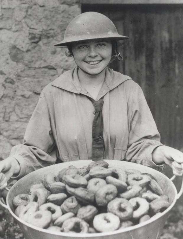 Salvation Army lassie Stella Young holds a pan of doughnuts for service members during World War II. (The Salvation Army)