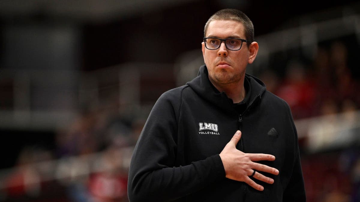 Head coach Trent Kersten signaling to players during volleyball match at Stanford Maples Pavilion