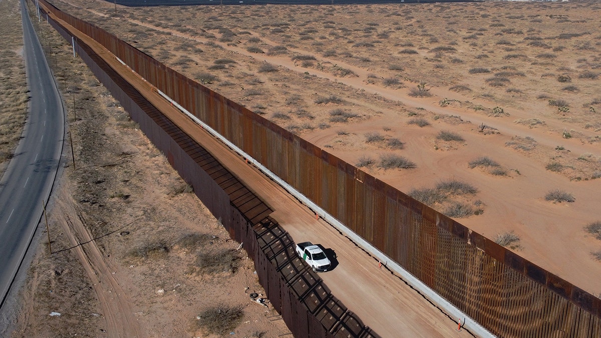 A US Border Patrol pickup parked next to a border wall under construction in Santa Teresa, New Mexico