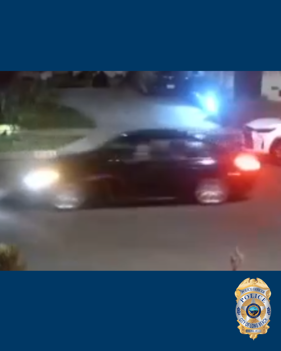 Blurry photo of a black sedan automobile at night.
