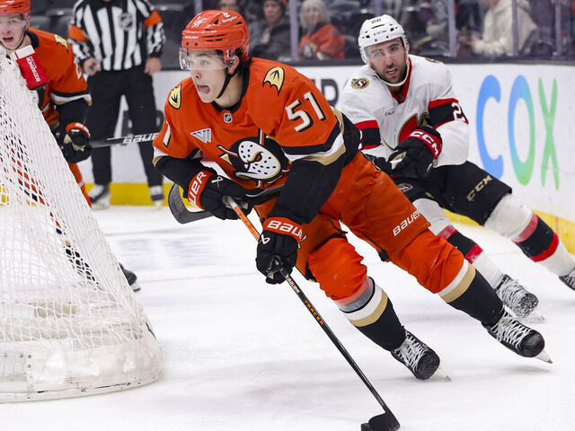 ANAHEIM, CALIFORNIA - DECEMBER 1: Olen Zellweger #51 of the Anaheim Ducks skates past Michael Amadio #22 of the Ottawa Senators during the third period of a game at Honda Center on December 1, 2024 in Anaheim, California.