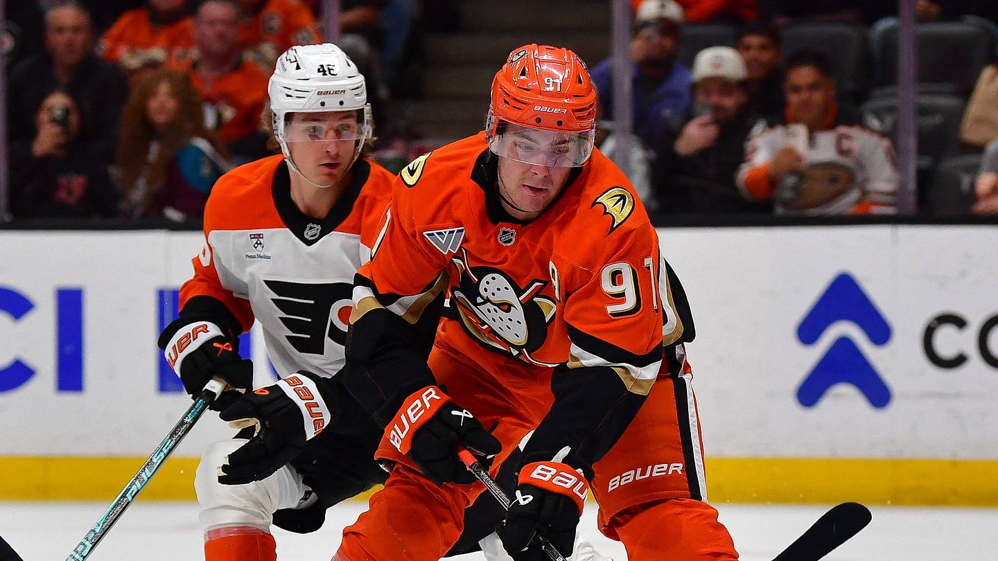 Mar 18, 2026; Anaheim, California, USA; Anaheim Ducks center Leo Carlsson (91) moves in for a shot as Philadelphia Flyers defenseman Cam York (8) and center Trevor Zegras (46) help goaltender Dan Vladar (80) defend the goal during the overtime period at Honda Center. Mandatory Credit: Gary A. Vasquez-Imagn Images