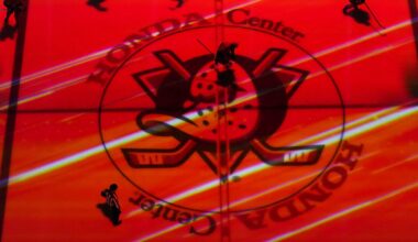 Apr 13, 2025; Anaheim, California, USA; Colorado Avalanche and Anaheim Ducks players skate across the Ducks logo at center ice in the second period at Honda Center. Mandatory Credit: Kirby Lee-Imagn Images