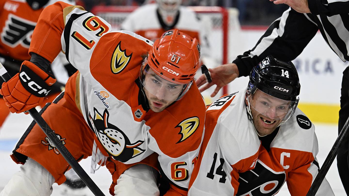 Jan 6, 2026; Philadelphia, Pennsylvania, USA; Anaheim Ducks left wing Cutter Gauthier (61) and Philadelphia Flyers center Sean Couturier (14) battle after a face-off during the first period at Xfinity Mobile Arena. Mandatory Credit: Eric Hartline-Imagn Images