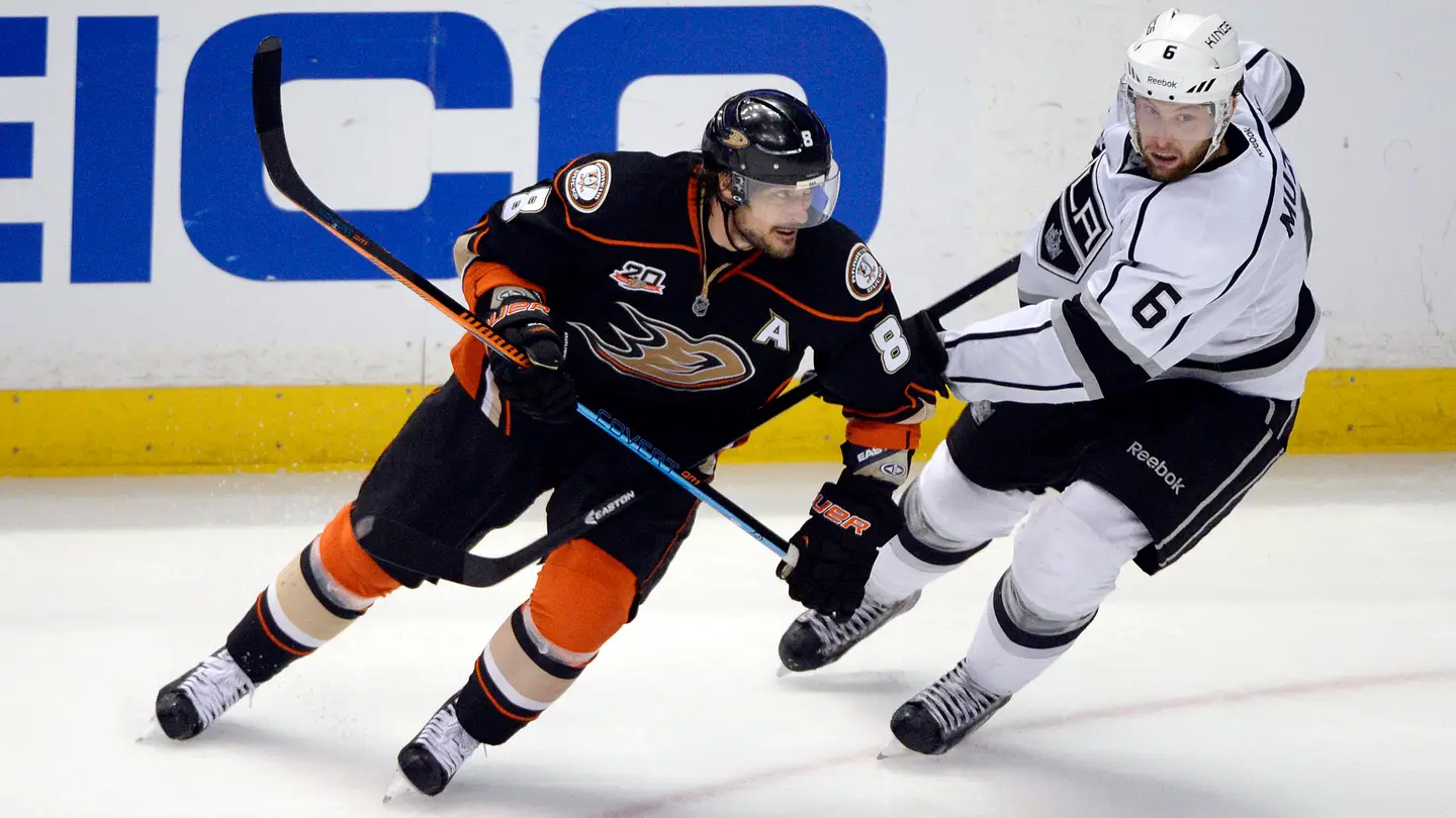 May 16, 2014; Anaheim, CA, USA; Anaheim Ducks right wing Teemu Selanne (8) skates around Los Angeles Kings defenseman Jake Muzzin (6) during the third period in game seven of the second round of the 2014 Stanley Cup Playoffs at Honda Center. Mandatory Credit: Robert Hanashiro-USA TODAY Sports