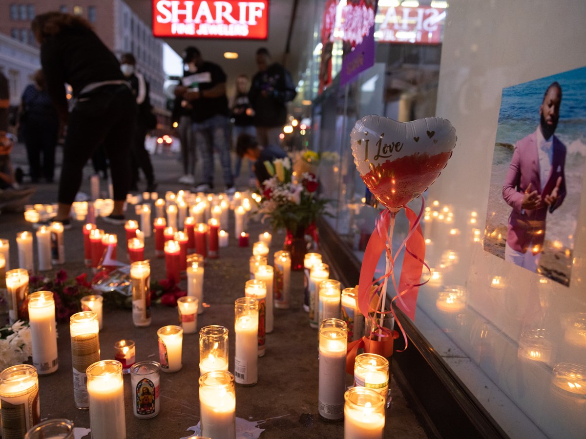 Mourners light candles on 10th and K Street in Downtown Sacramento, on Monday, April 4, 2022.