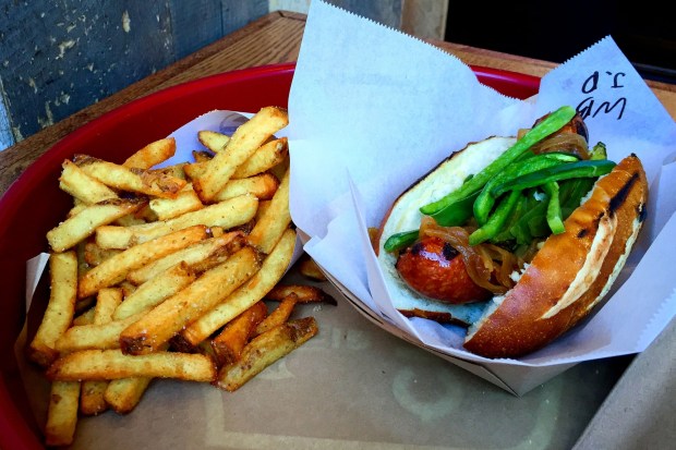 Smoked cheddar braturst dog and hand-cut fries at Wurshaus in Santa Ana. (Photo by Brad A. Johnson, Orange County Register/SCNG)