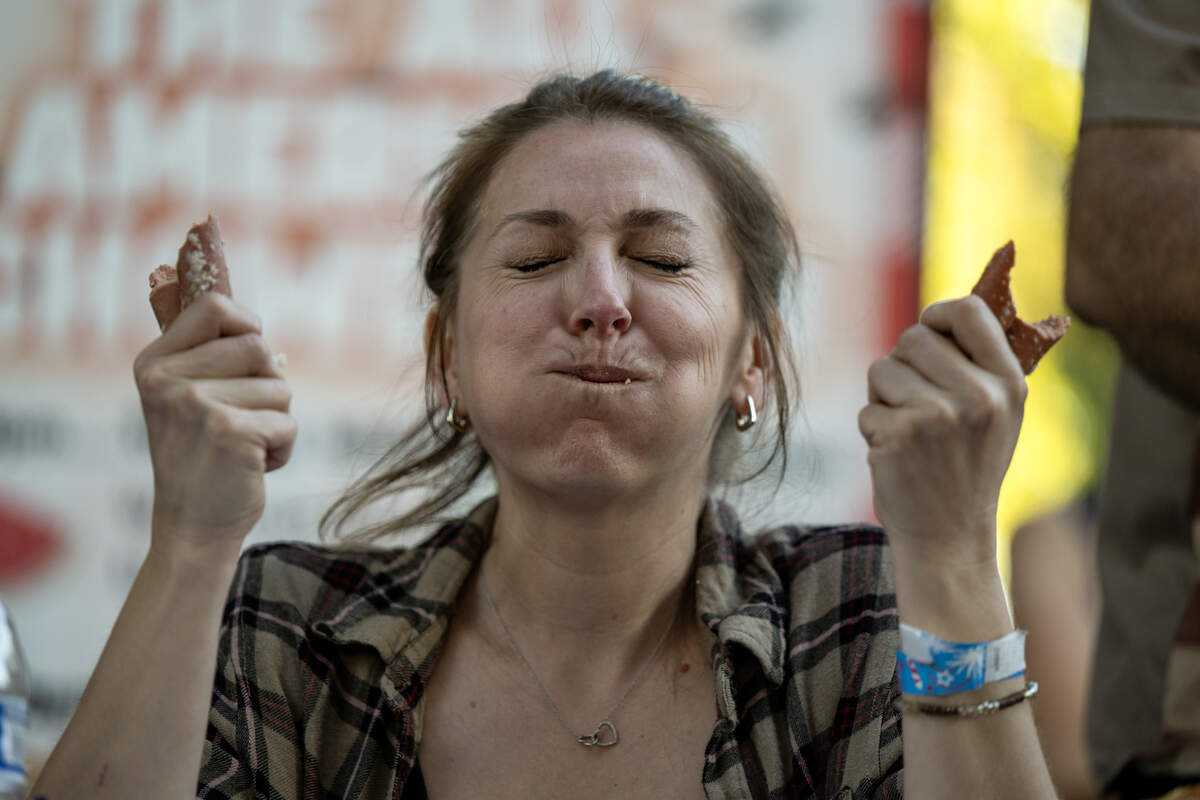 Kat Davis competes in the hot dog eating contest at the Fourth of July celebration at Hagan Community Park in Rancho Cordova on Friday, July 3.