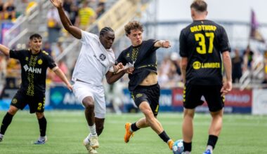 Pittsburgh Riverhounds defender Lasse Kelp holds off Louisville City FC's Tola Showunmi in the Hounds' 3-1 win on July 18, 2026 at F.N.B. Stadium in Pittsburgh. (Photo: Chris Cowger/Riverhounds SC)