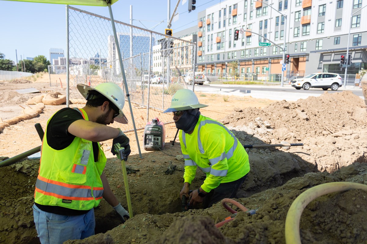 Construction workers Abel Muñoz (left) and Carlos Barrera putting in optic fiber for the Republic FC Stadium Tuesday, July 14, 2026, in the Sacramento Railyards.