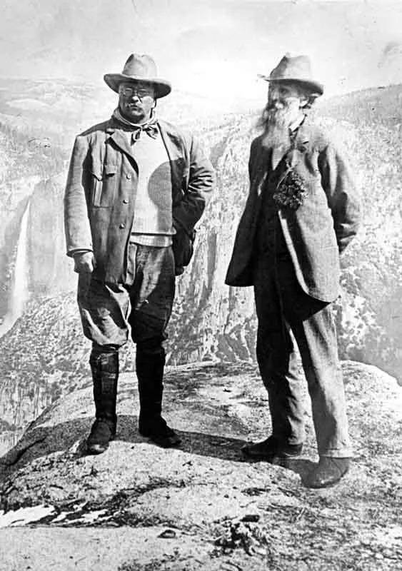 President Teddy Roosevelt and John Muir standing on rock at Glacier Point, Yosemite, May 1903; Yosemite Falls and cliffs of Yosemite Valley in distance.