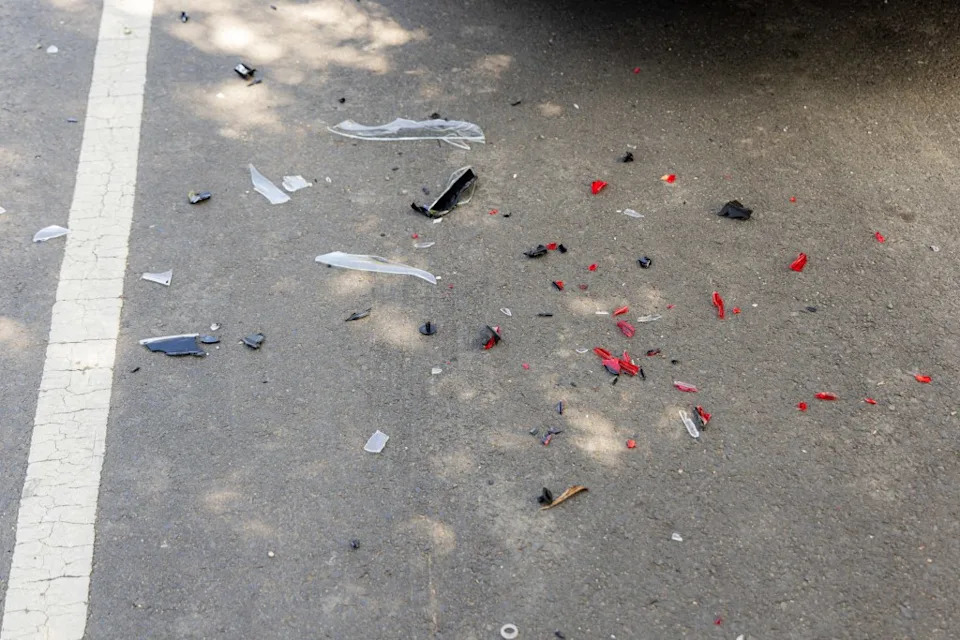 Surrounding the damaged Tesla was visible vehicle debris scattered along the street. Jason Henry for CA Post