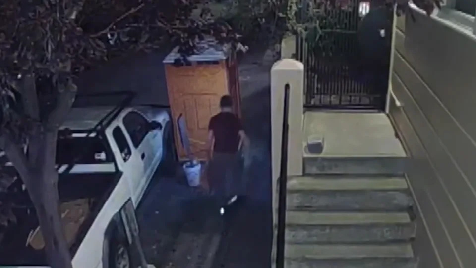 man stealing sewer grates