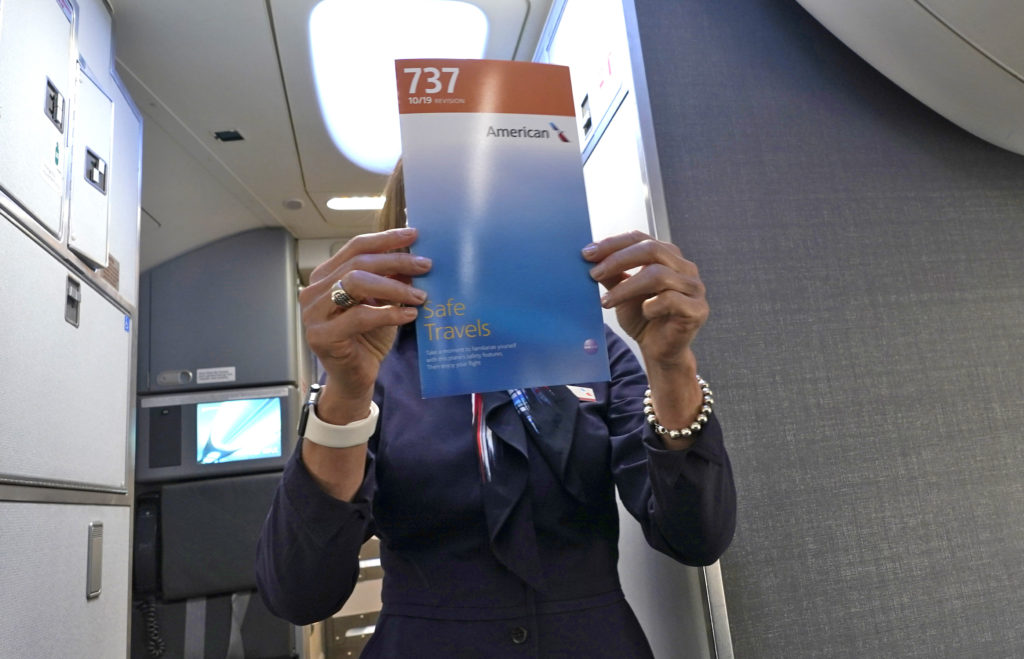 a woman holding a booklet in front of her face