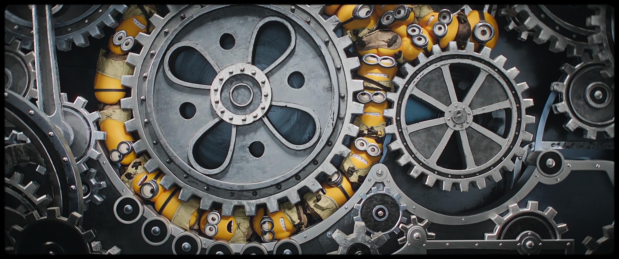 Minions get stuck between the cogs of a huge machine.