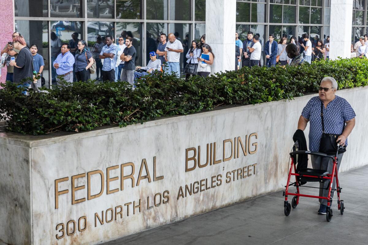 People wait in line to enter the Los Angeles - N. Los Angeles Street Immigration Court