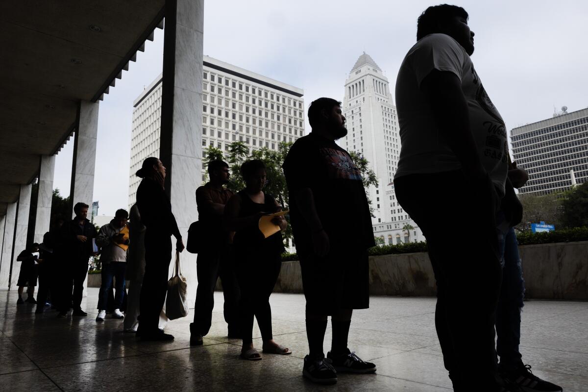 People wait in line to enter the Immigration Court 