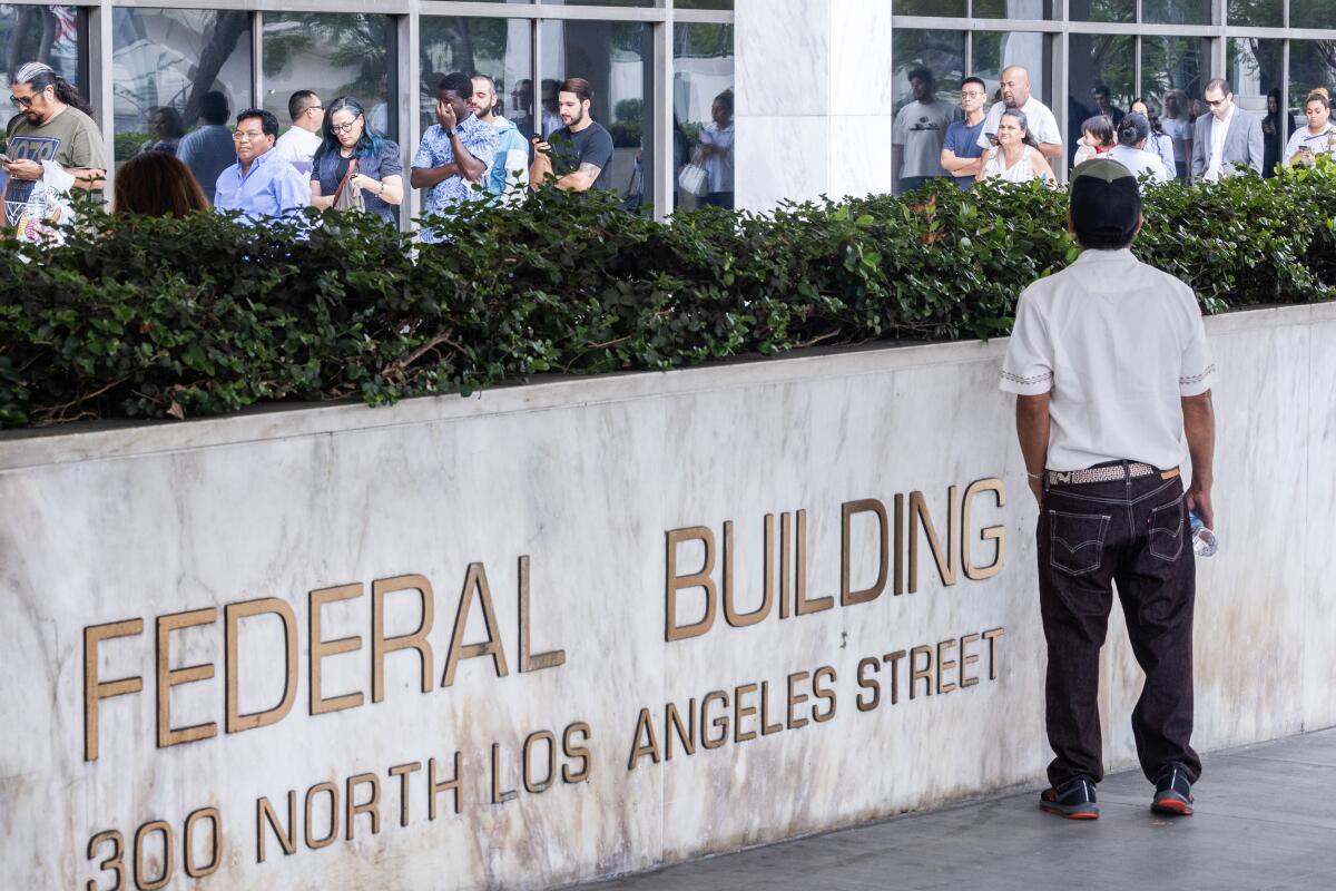 People wait in line to enter the Los Angeles - N. Los Angeles Street Immigration Court
