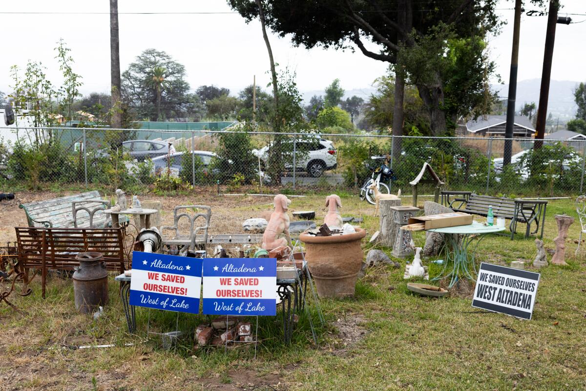 On property where a home once stood in Altadena, posters proclaim, "We saved ourselves."