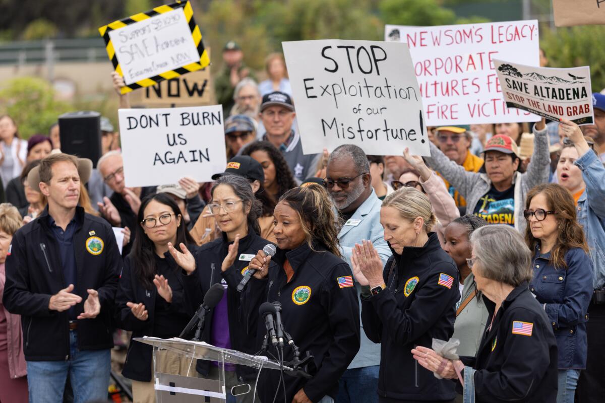 Altadena residents and council members gather at a fire-damaged residential property on East Las Flores Drive .