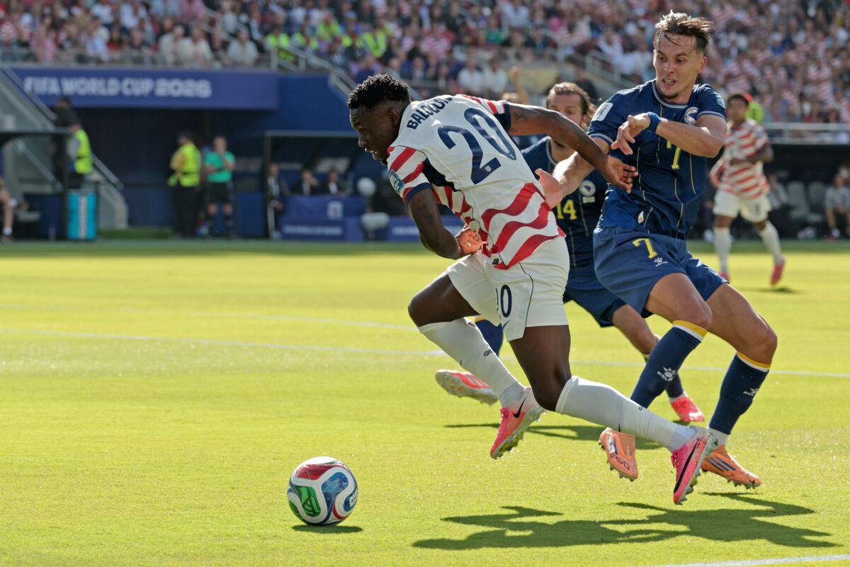 Folarin Balogun and Bosnia-Herzegovina defender Amar Dedic in action during the first half.