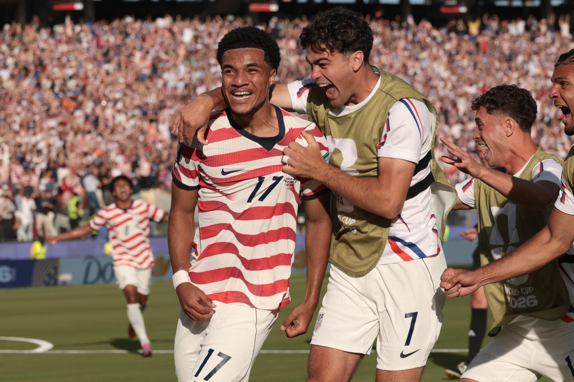 U.S. midfielder Malik Tillman celebrates with Giovanni Reyna and teammates after scoring against Bosnia-Herzegovina.