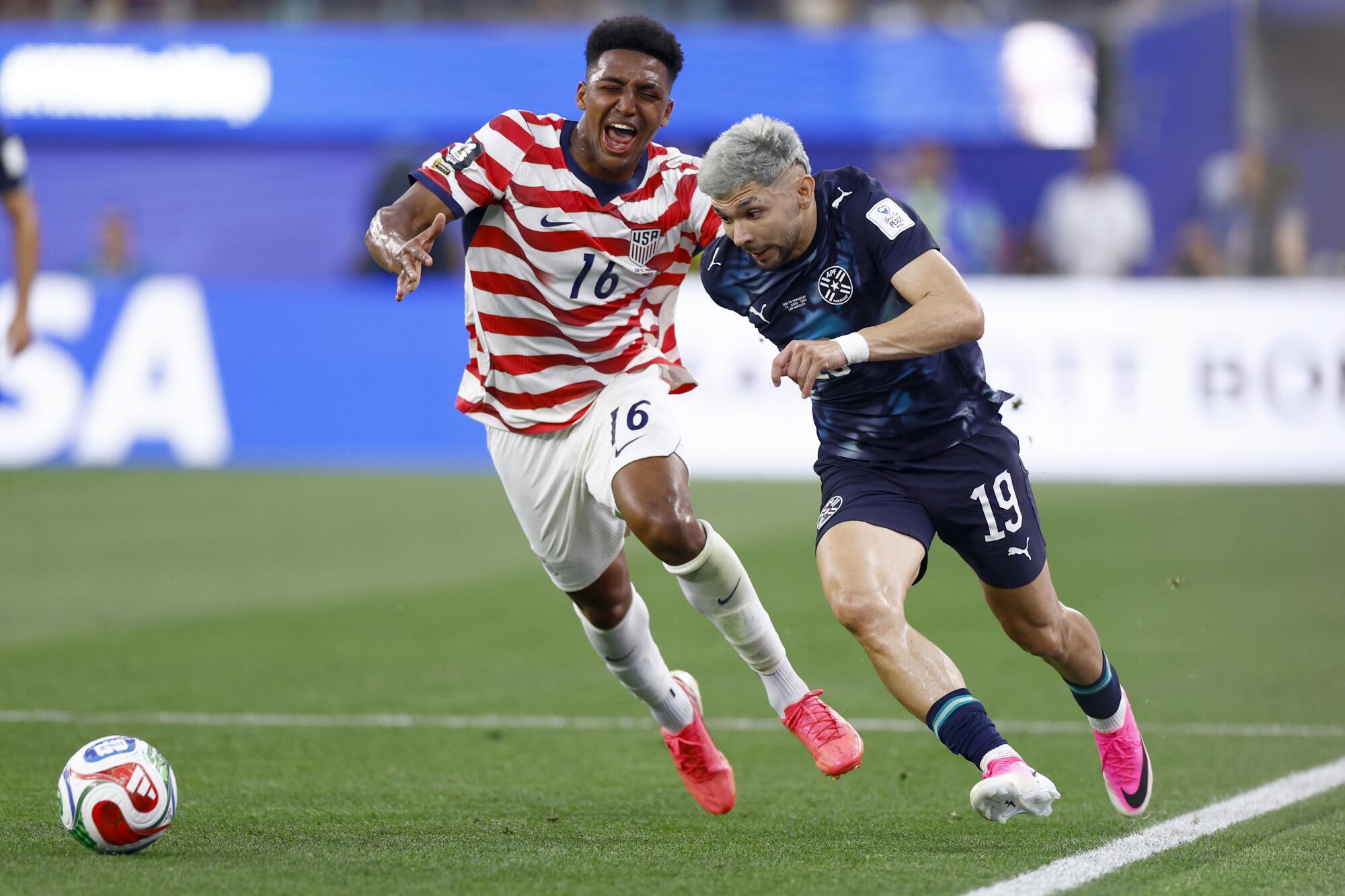 U.S. defender Alex Freeman, left, and Paraguay forward Julio Enciso battle for control of the ball.