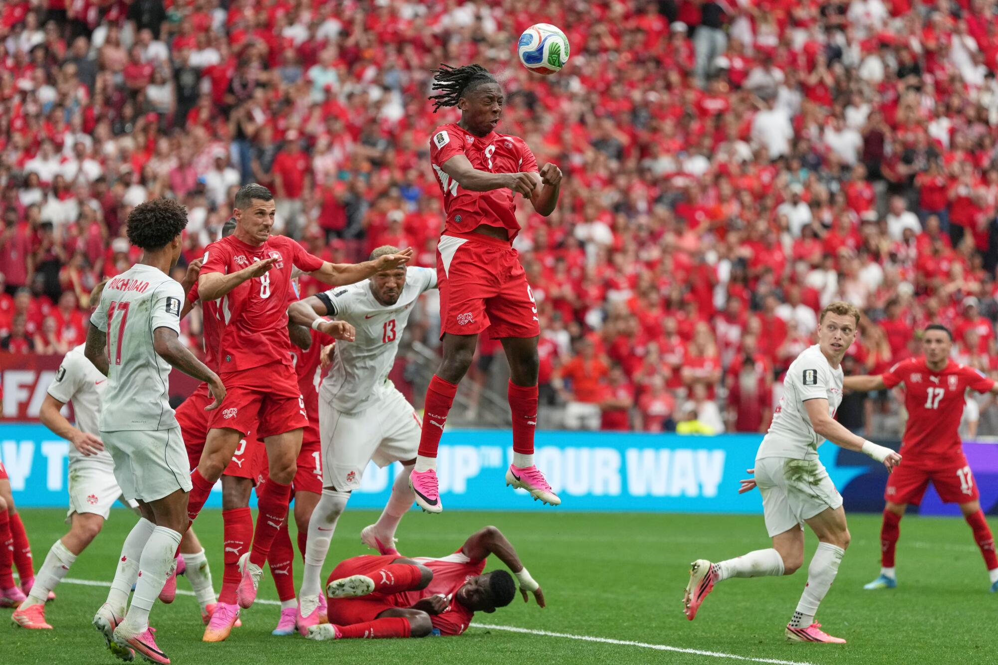 Switzerland's Johan Manzambi heads the ball against Canada at the World Cup on June 24.