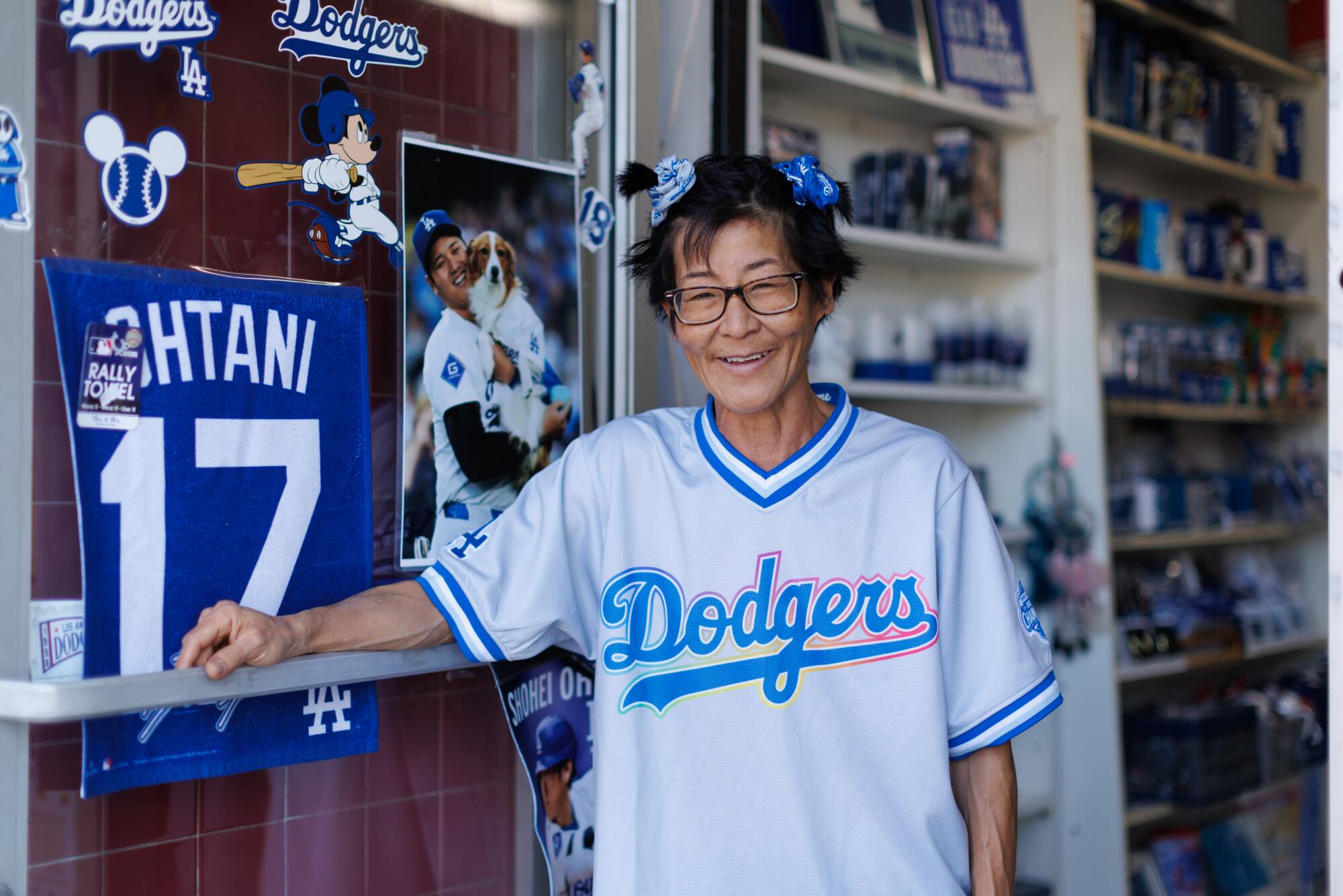 A person standing in front of a shop with LA Dodgers merchandise.