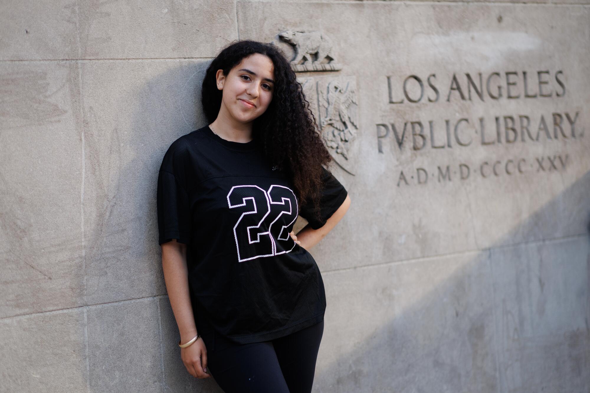 A person standing outside the L.A. Public Library.
