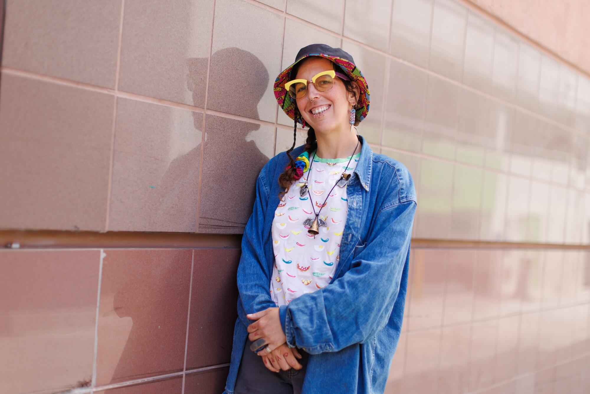 A person standing against a tiled wall in Santa Monica.