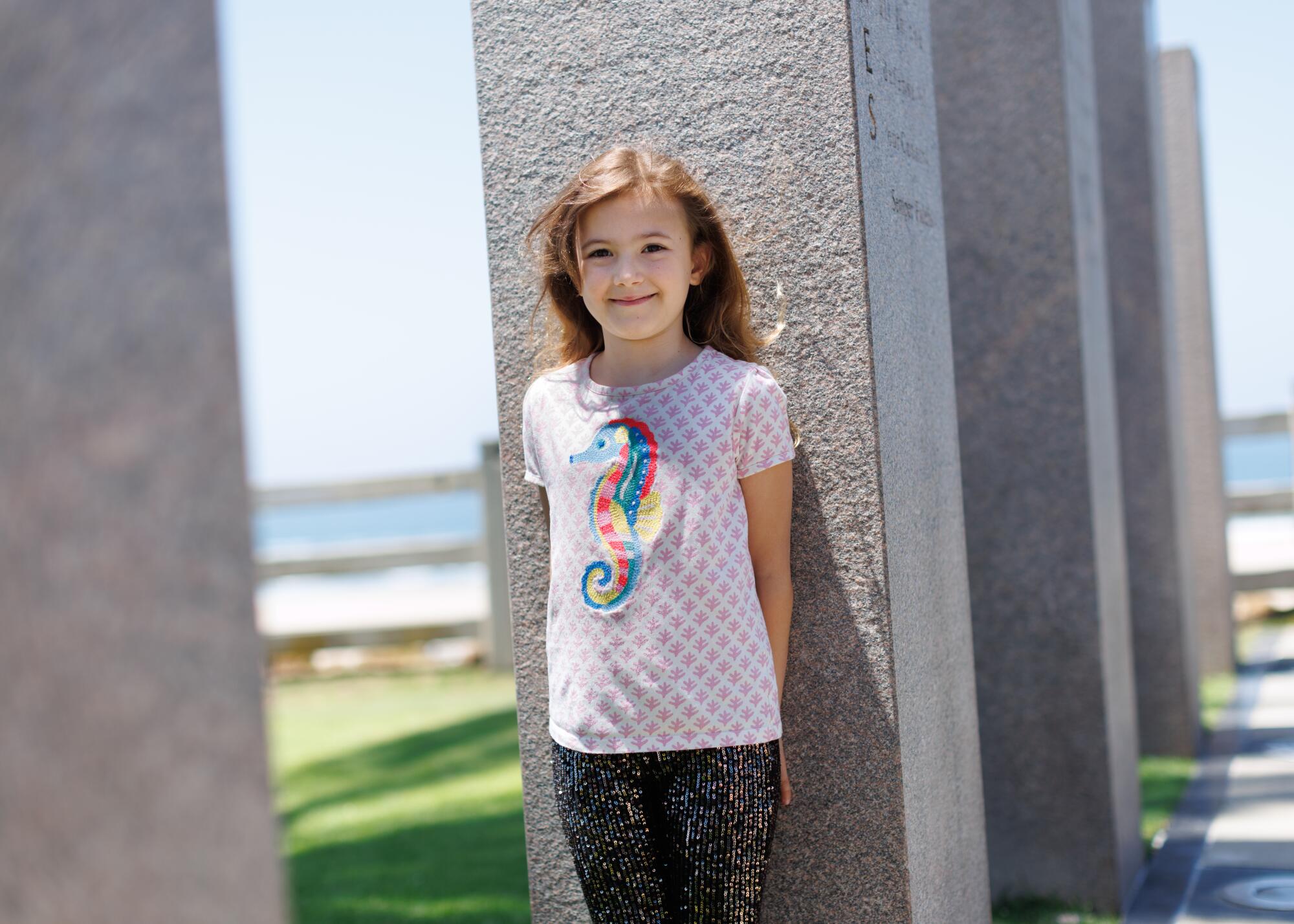 A young child standing at the Veterans Memorial in Santa Monica