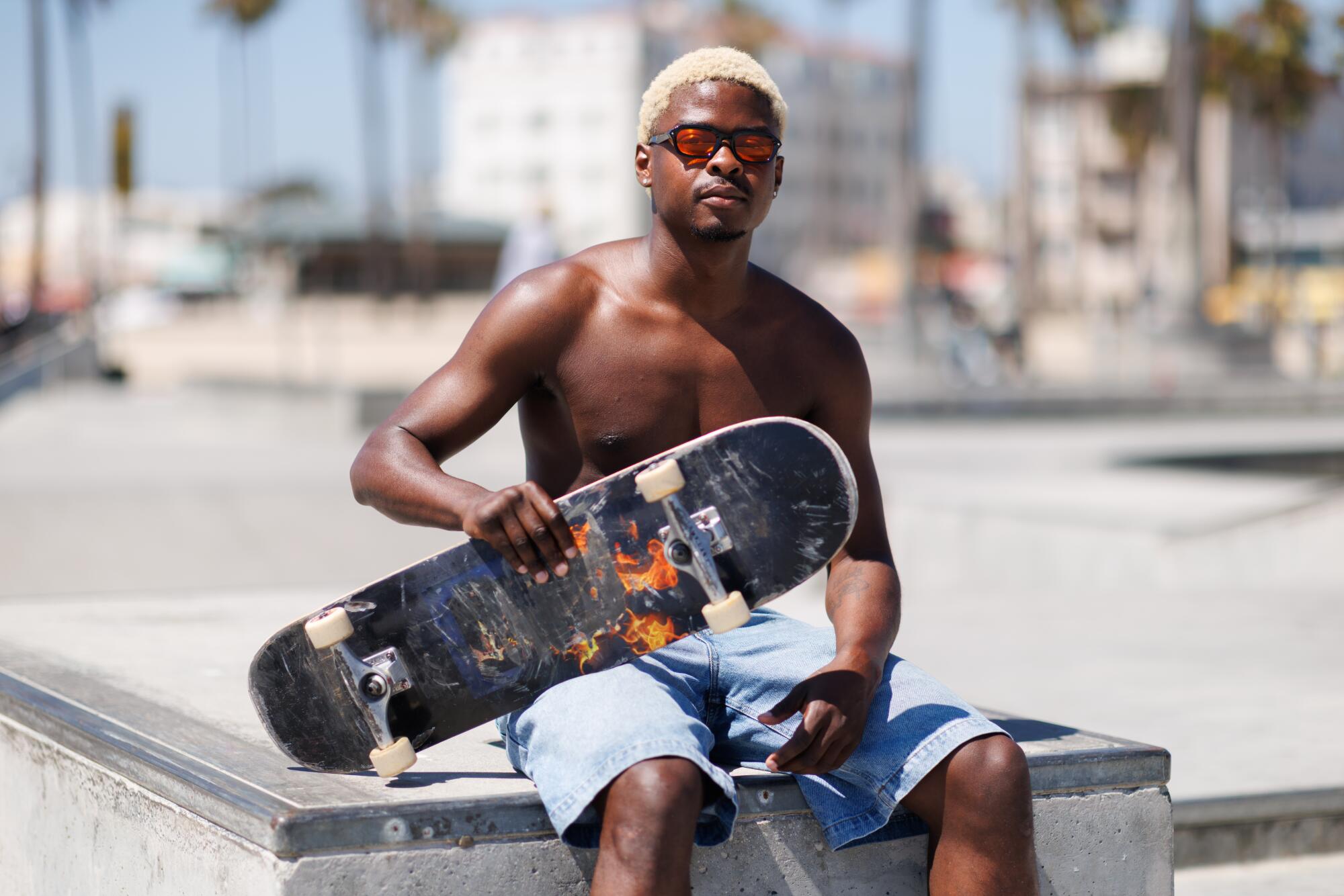 A person sitting at a skate park.