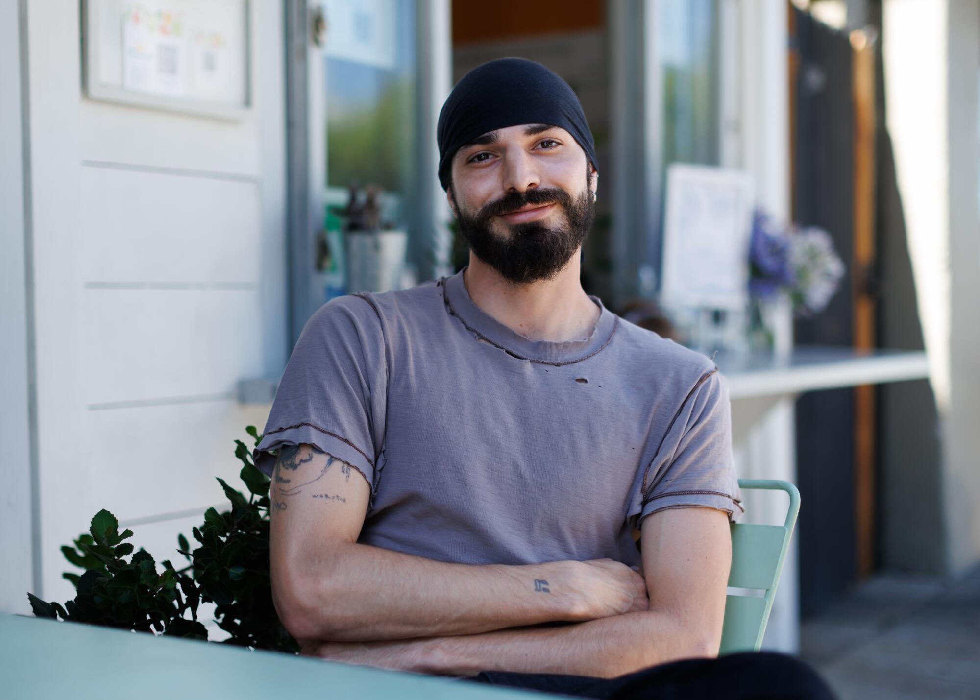 A person sitting outside a coffee shop in Little Armenia.