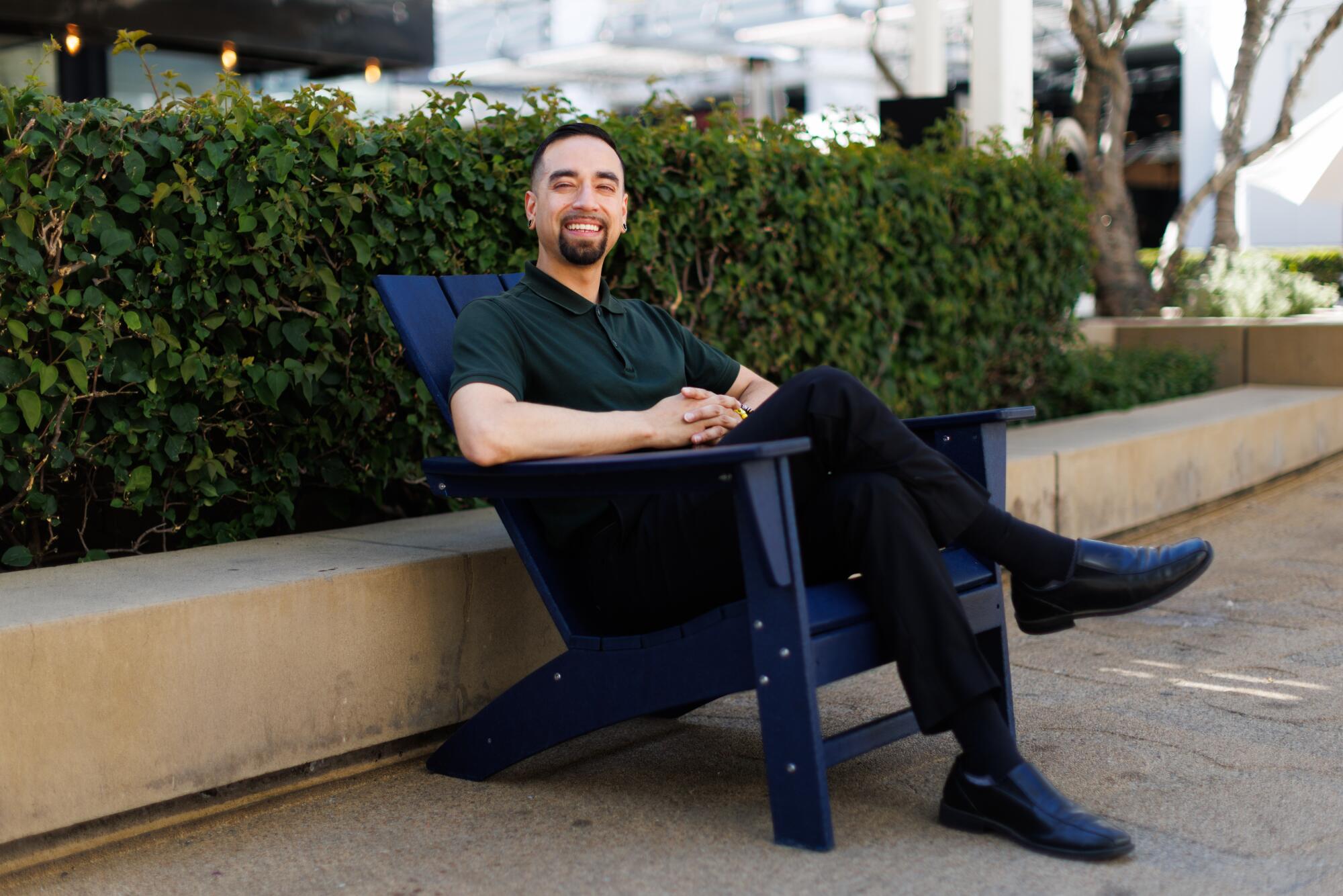 A person sits in a chair outside in Topanga Village.