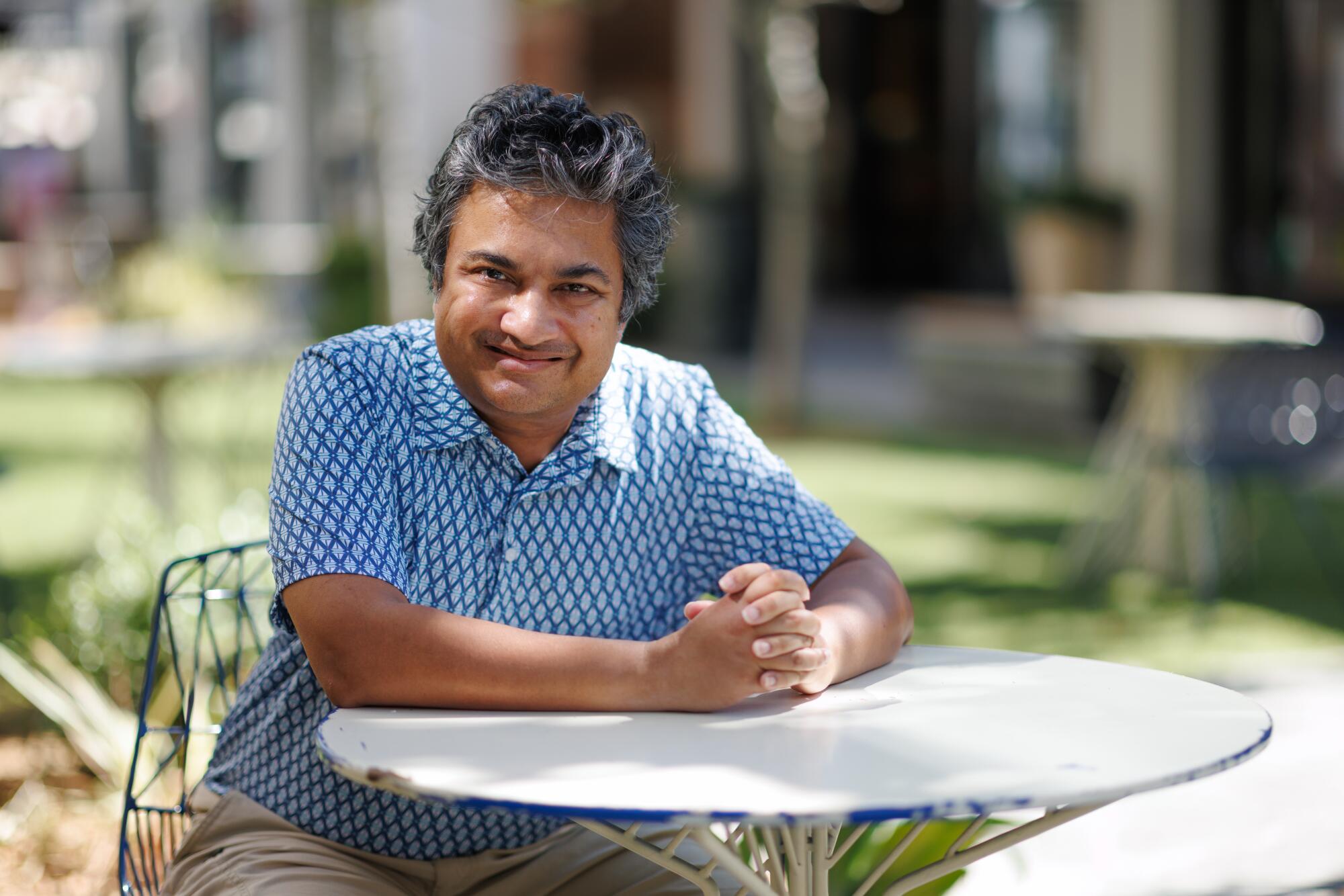 A person sits at a table in Topanga Village.