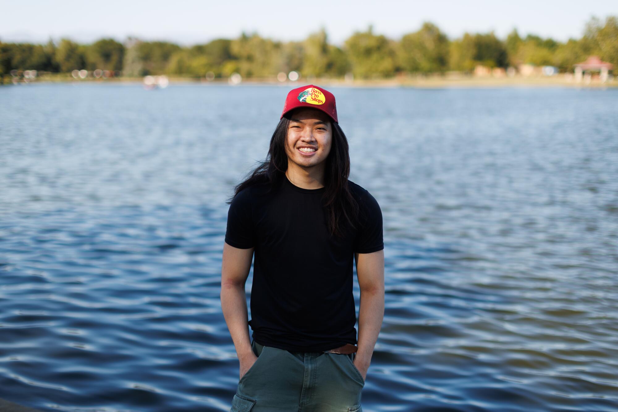 A person standing in front of a lake.