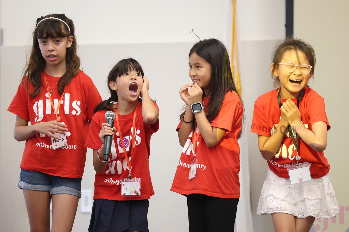 A team of youngsters react to winning the top bid for their Glow 'n' Hug Paradise.