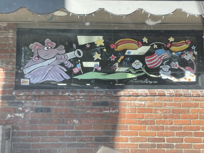 A Fourth of July themed illustration pictured on a store window.