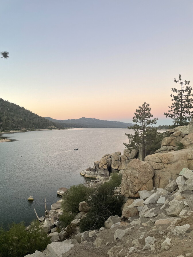 A reservoir pictured at sunset in the mountains.
