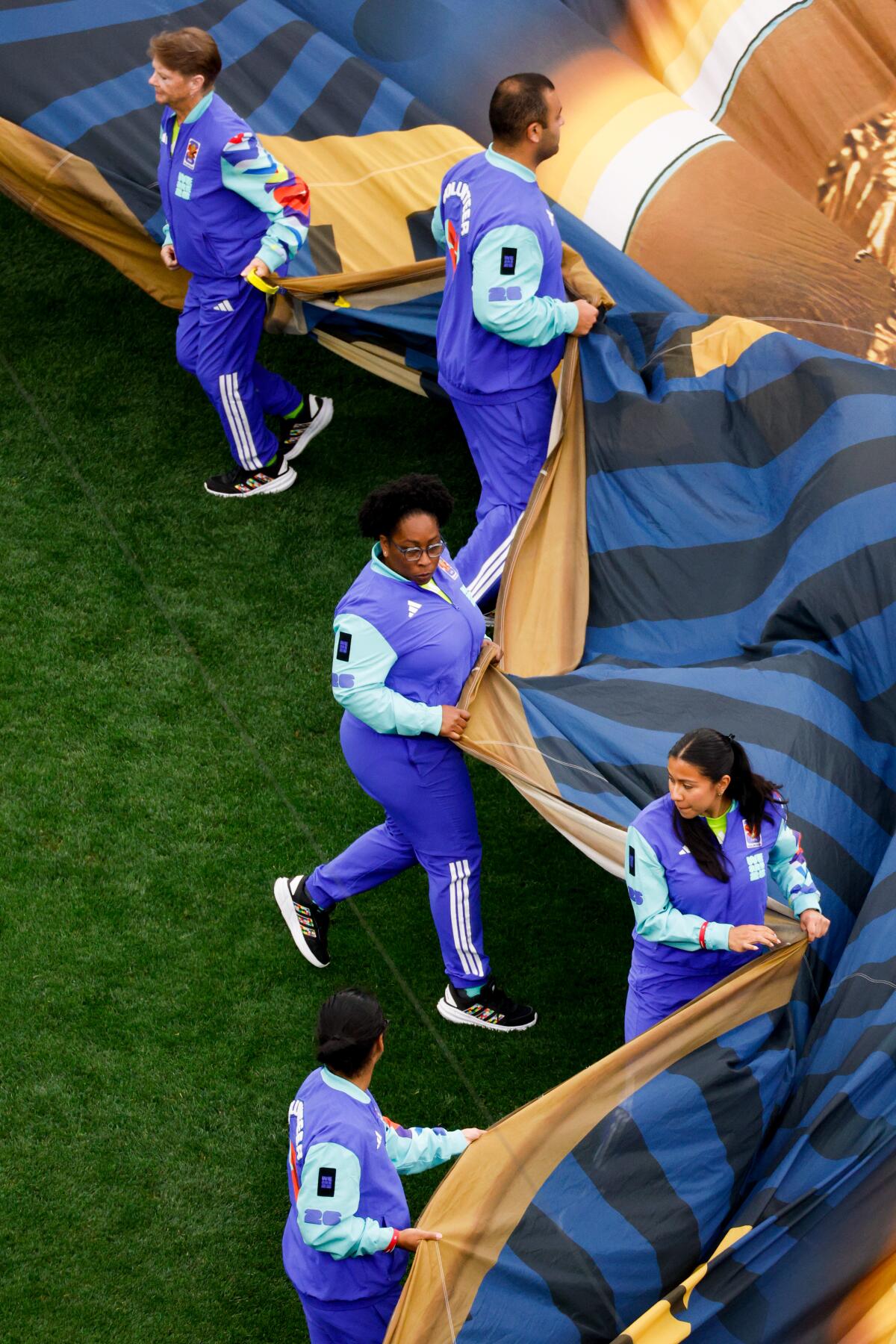 Volunteers unravel the center field display.